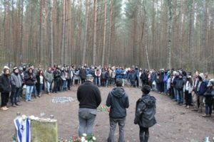 Students leading a memorial ceremony for their peers at Łopuchowo, the site of a Nazi massacre of Polish Jews